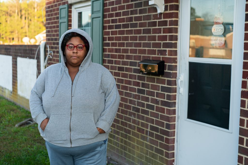 Tawna Thomas, 26, stands in front of her house owned by the Housing Authority of Crisfield in Somerset County, Maryland, on Nov. 7. Thomas said she has struggled to pay her $138 monthly rent during the pandemic and worries she might receive an eviction notice soon. (Nick McMillan/Howard Center)
